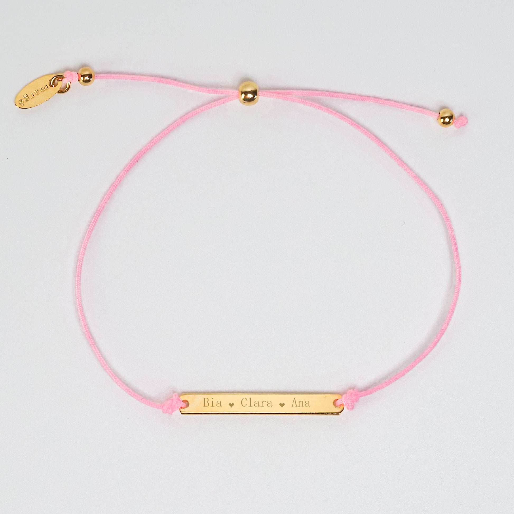 Pulseira inicial plaquinha rosa dourada - margê atelier