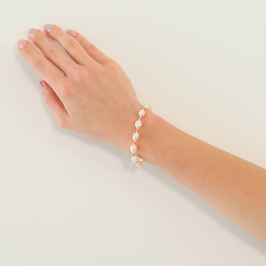 Pulseira pérola pêssego dourada