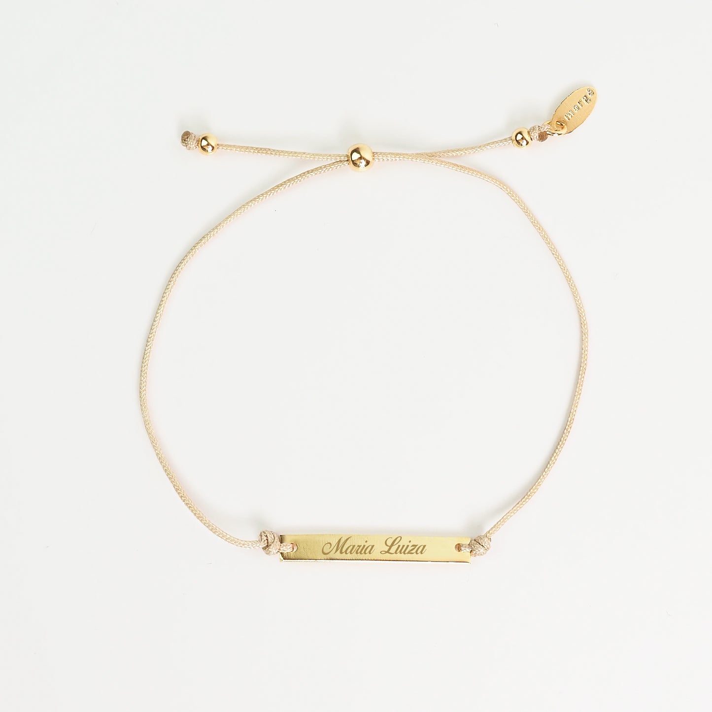 Pulseira inicial plaquinha creme dourada