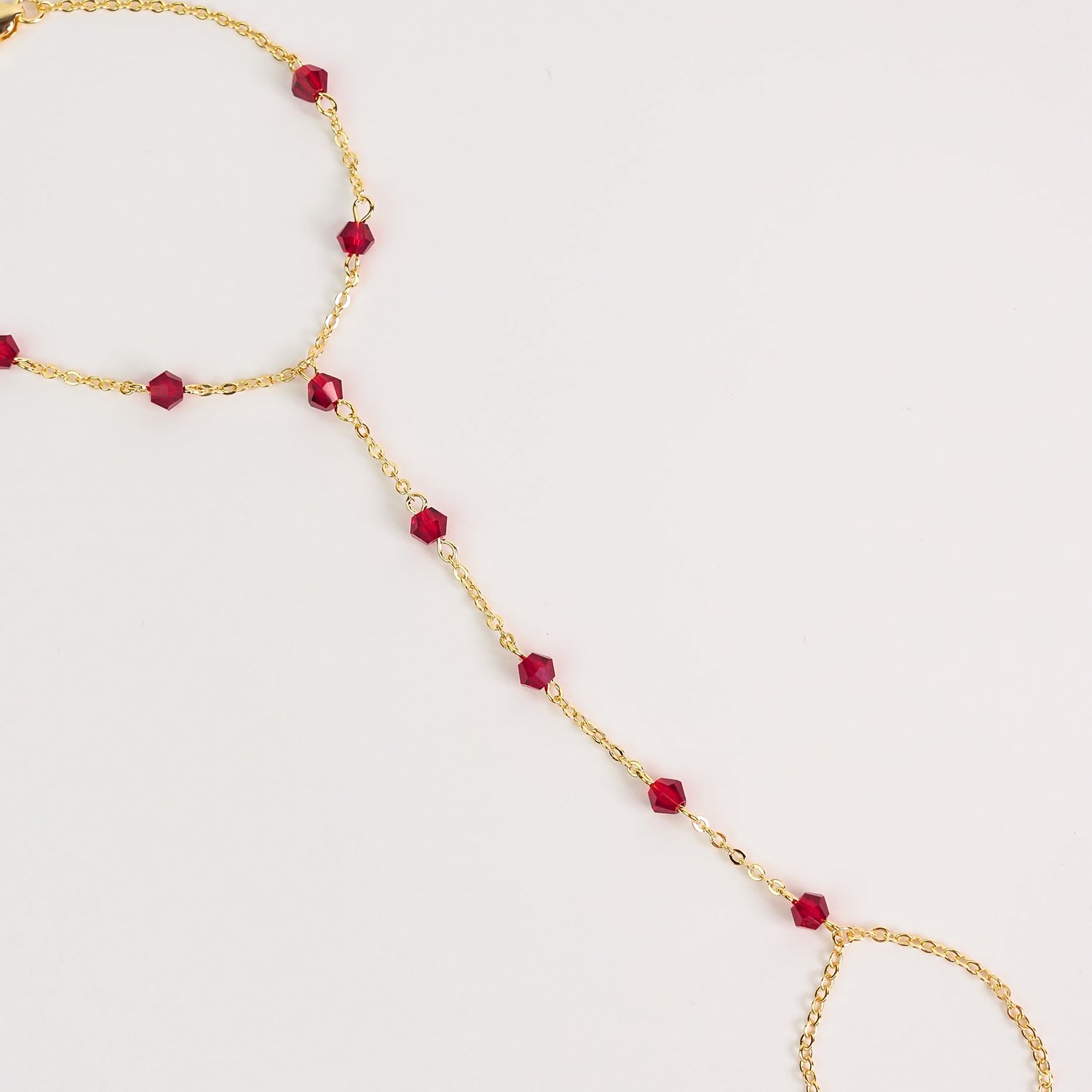Handchain pedrinhas vermelhas dourado